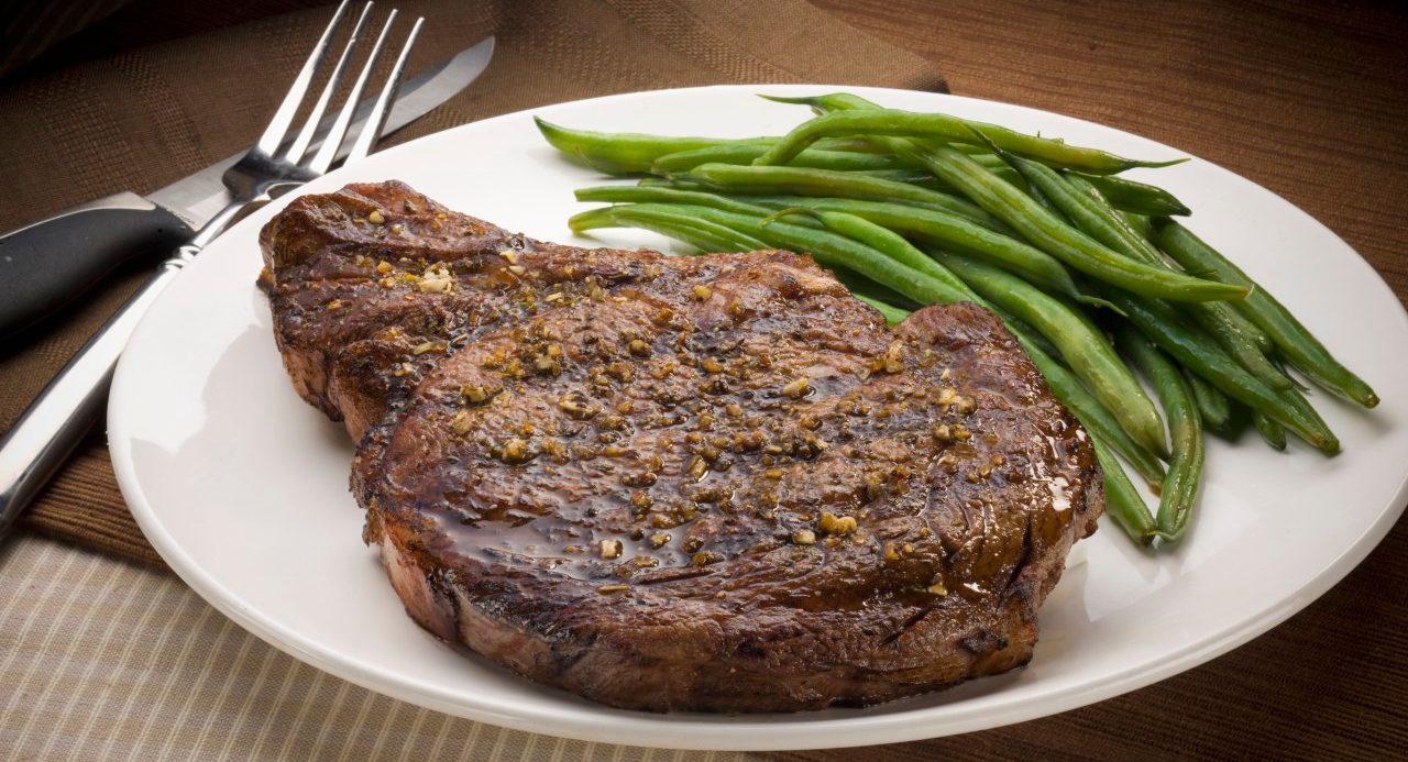 Rib-eye steak and green beans --- Image by © Rick Gayle Studio/Corbis