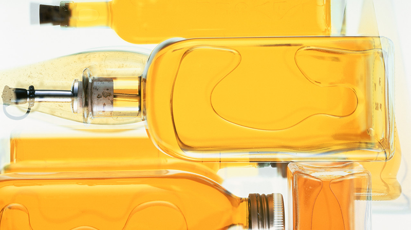 Bottles of cooking oil --- Image by © Christian Schmidt/Corbis