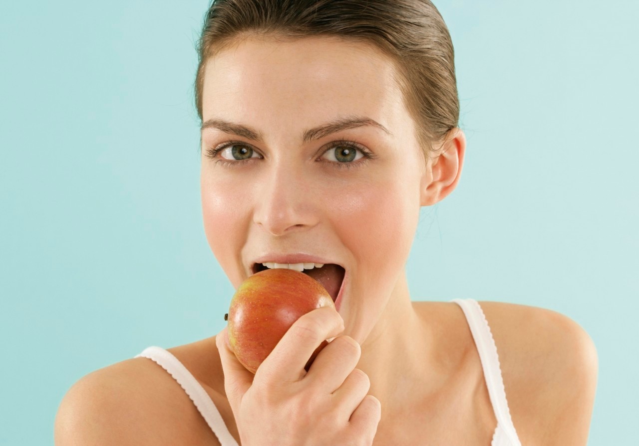 Woman eating an apple --- Image by © RG Images/Stock4B/Corbis