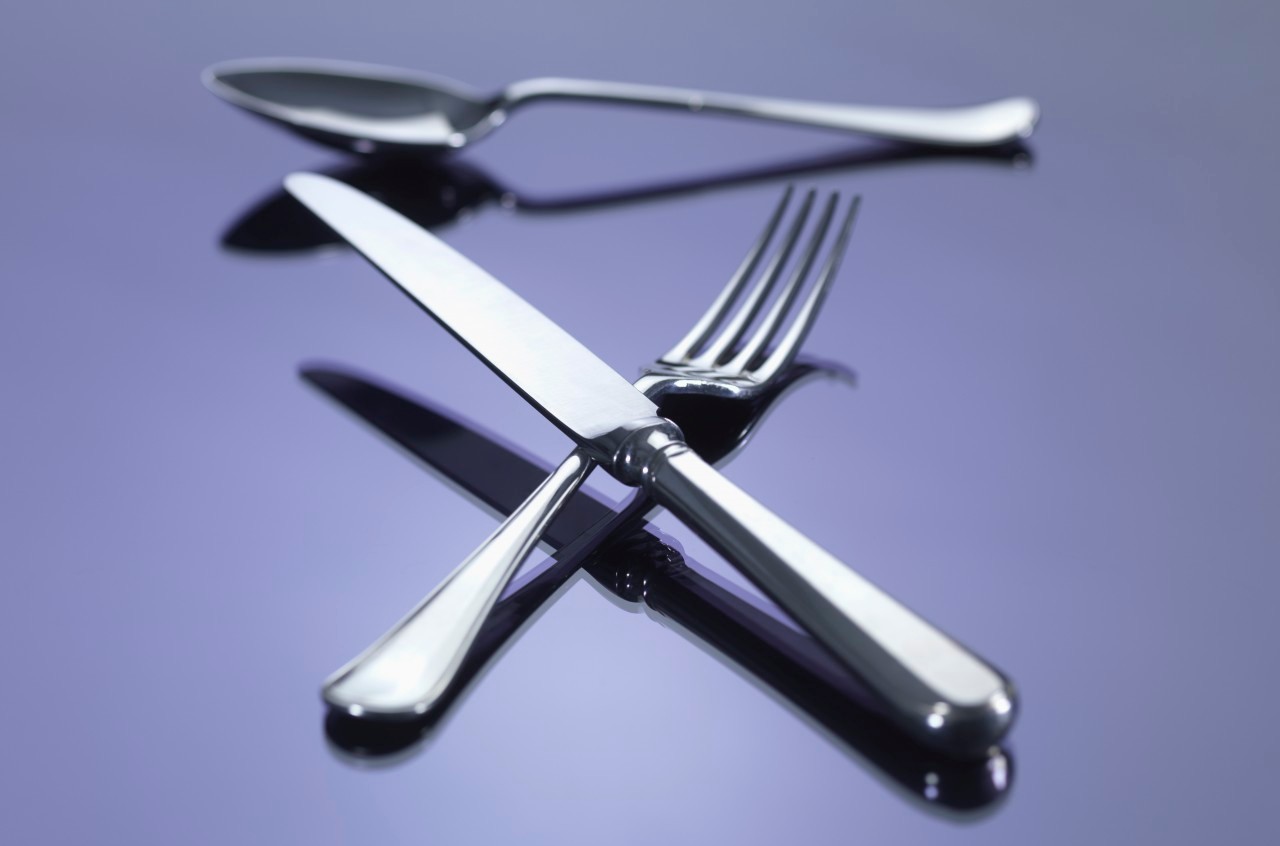 16 Mar 2012 --- Knife, and fork in cross shape with spoon --- Image by © Rafe Swan/Corbis
