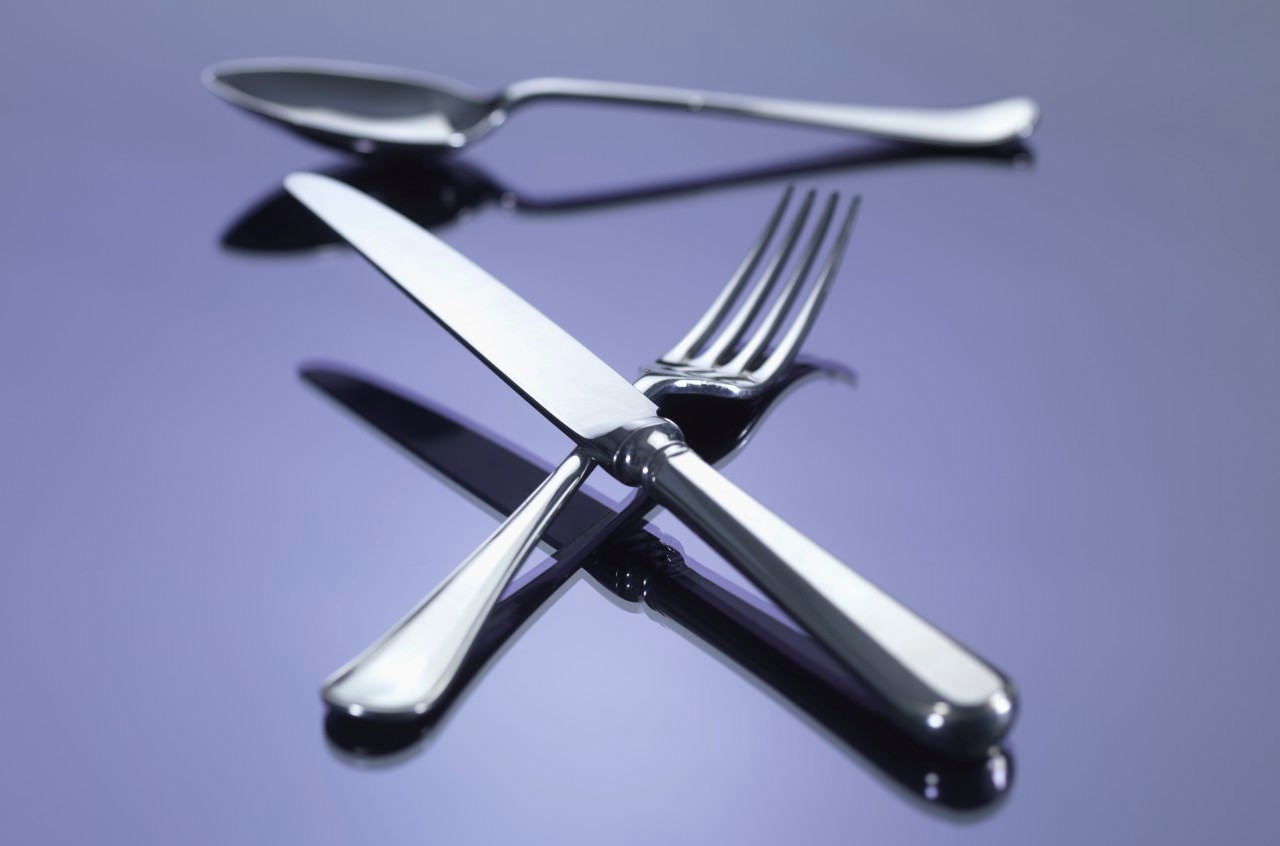 0042-11-30T00:00:00.000Z 16 Mar 2012 --- Knife, and fork in cross shape with spoon --- Image by © Rafe Swan/Corbis