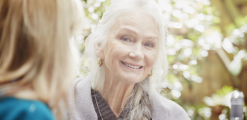 30 Mar 2015, London, England, UK --- Senior woman with grey hair in garden, portrait --- Image by © Phillip Waterman/Corbis