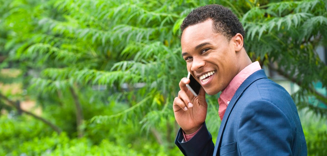 17 Jun 2014 --- Young businessman in city park chatting on smartphone --- Image by © Leland Bobbe/Image Source/Corbis