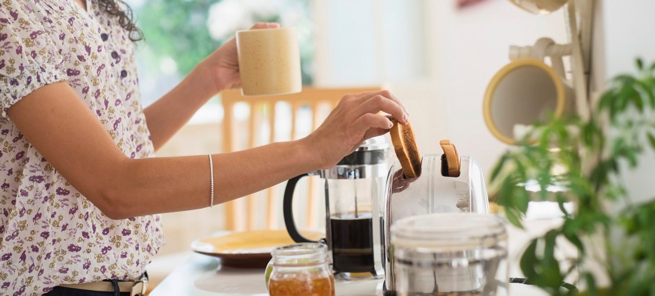 18 Sep 2014 --- Mixed race woman preparing breakfast in kitchen --- Image by © JGI/Tom Grill/Blend Images/Corbis