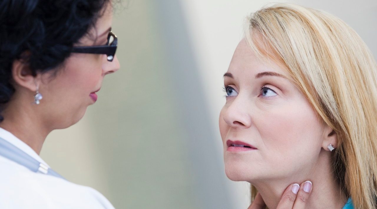 Doctor examining patient's lymph nodes --- Image by © Kate Kunz/Corbis