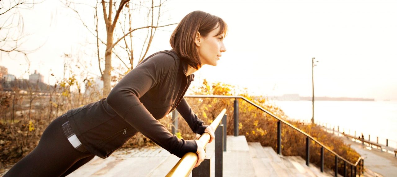 04 Dec 2012 --- Female runner working out on park railing --- Image by © Cavan Images/Corbis