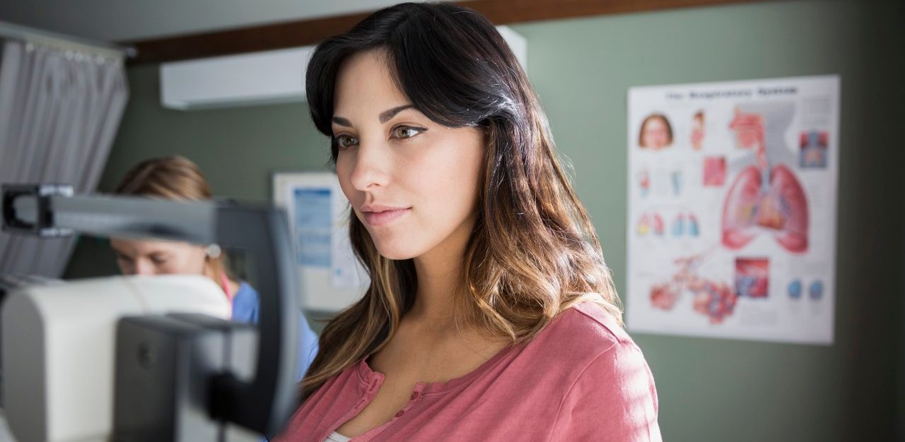 10 Dec 2014 --- Woman on weight scale in examination room --- Image by © Hero Images Inc./Hero Images Inc./Corbis