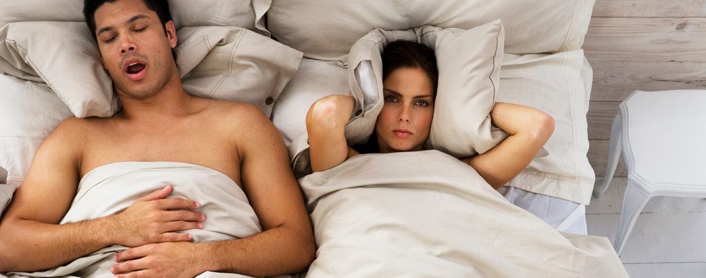 Woman Trying to Sleep While Man Snores --- Image by © Roy McMahon/Corbis