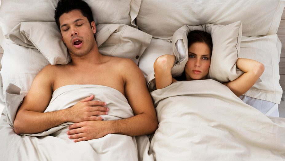 Woman Trying to Sleep While Man Snores --- Image by © Roy McMahon/Corbis