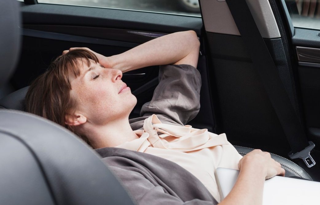 17 Aug 2014 --- Germany, portrait of businesswoman relaxing in a car --- Image by © Jo Kirchherr/Westend61/Corbis
