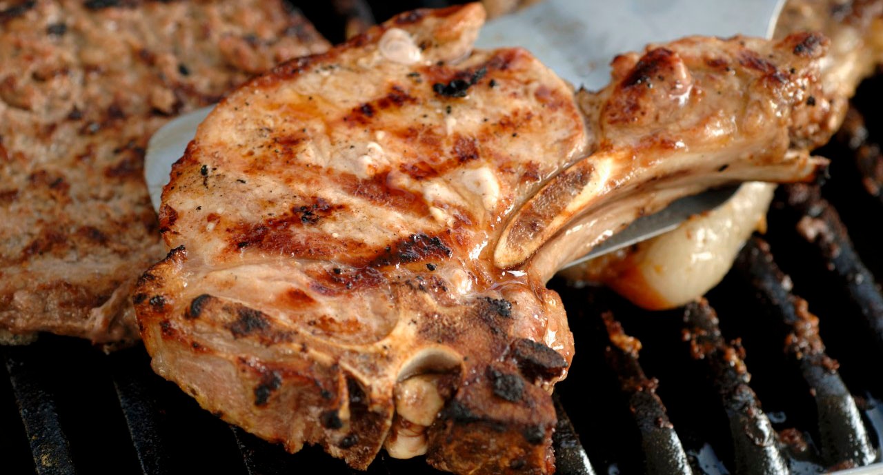 30 May 2008 --- Pork chop on barbecue --- Image by Â© the food passionates/Corbis