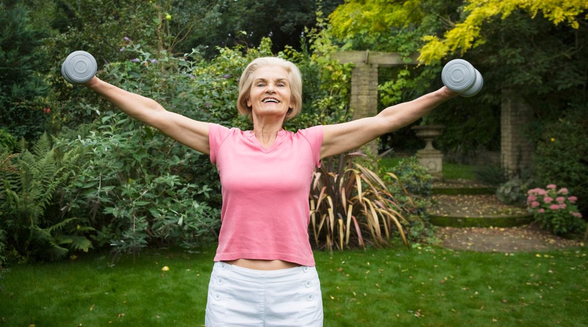 Woman Lifting Weights --- Image by © Betsie van der Meer/Corbis