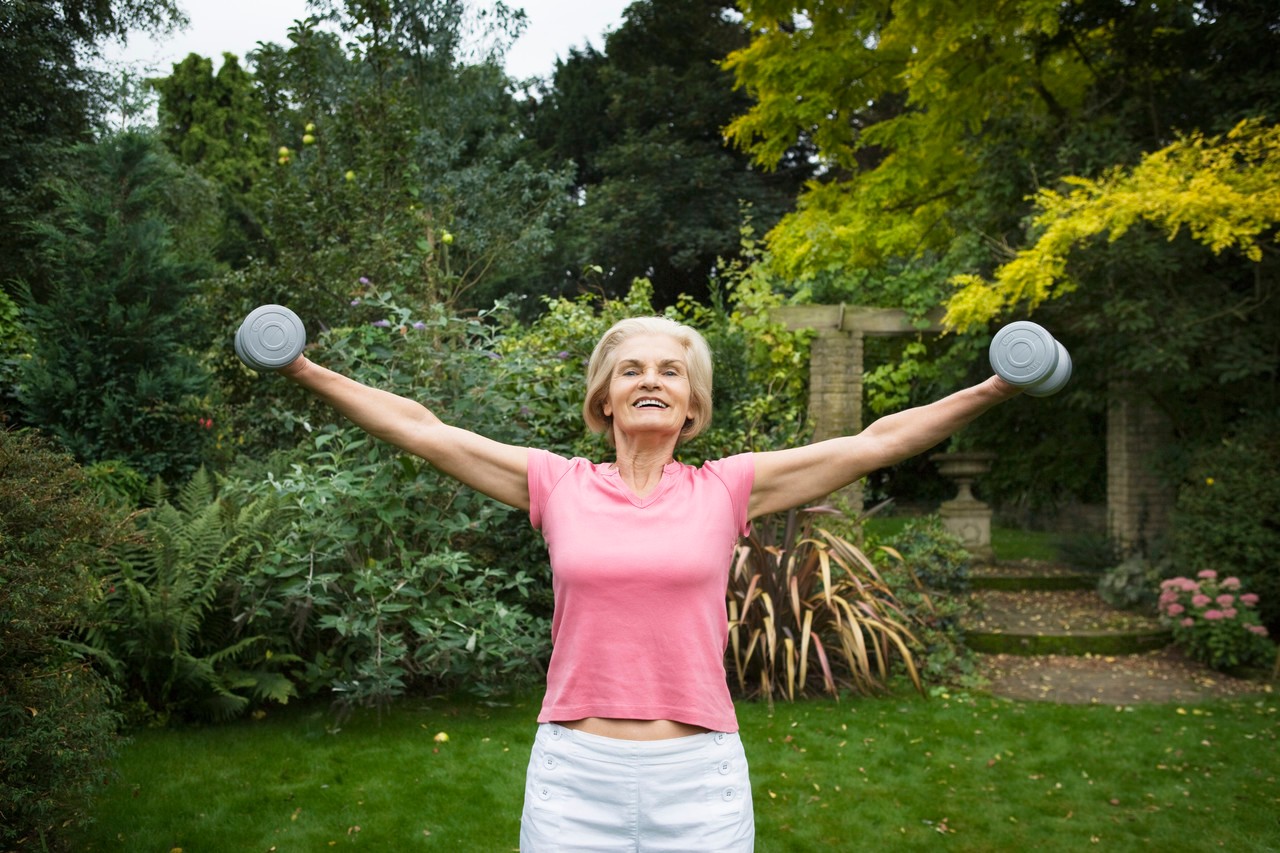 Woman Lifting Weights --- Image by © Betsie van der Meer/Corbis