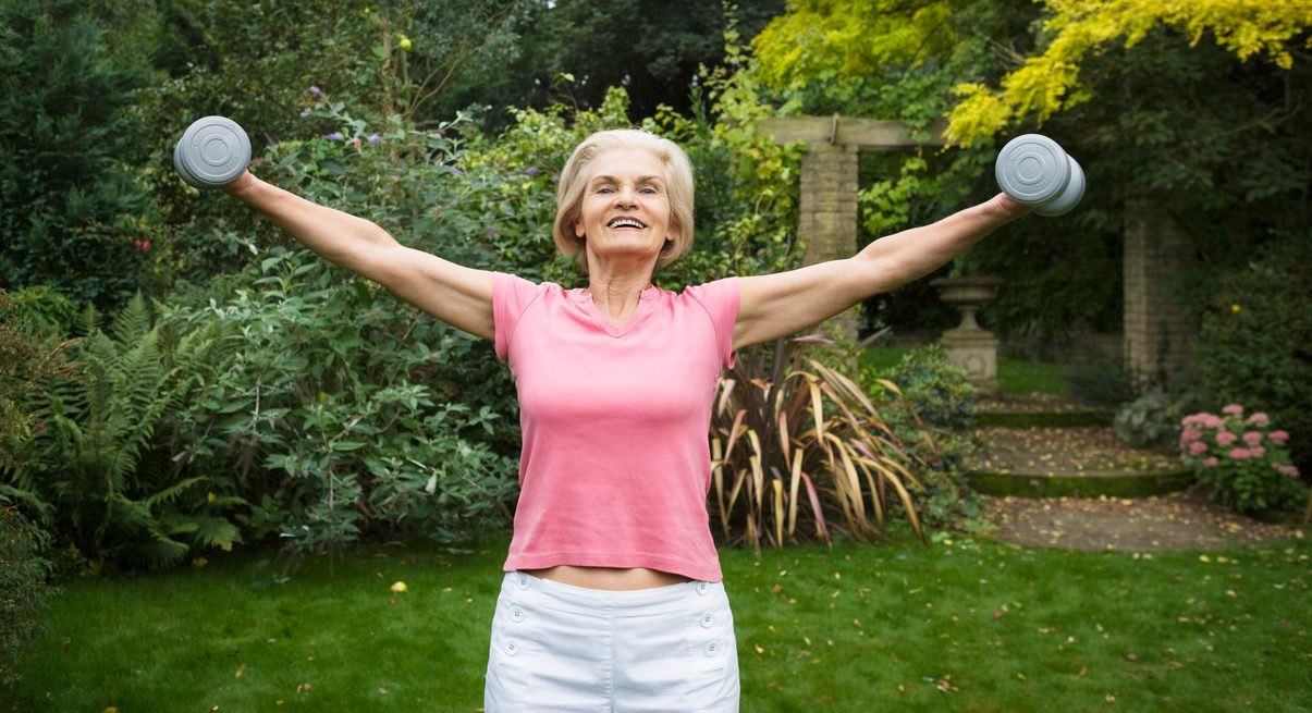 Woman Lifting Weights --- Image by © Betsie van der Meer/Corbis