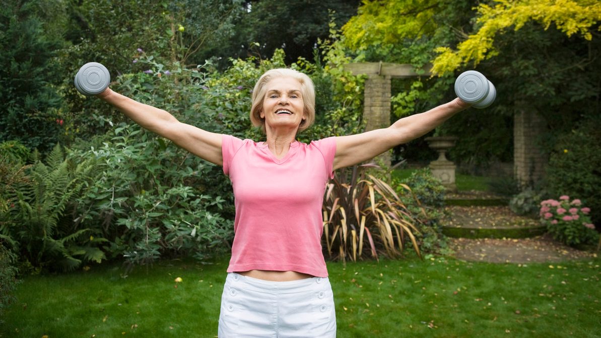 Woman Lifting Weights --- Image by © Betsie van der Meer/Corbis