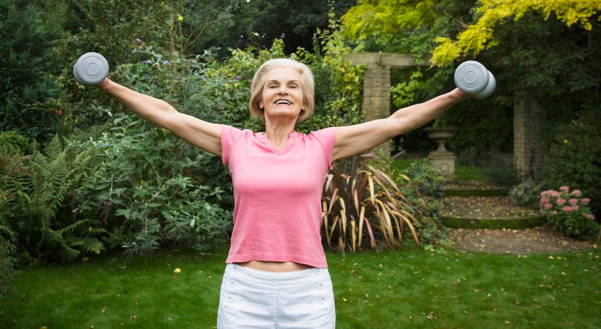 Woman Lifting Weights --- Image by © Betsie van der Meer/Corbis